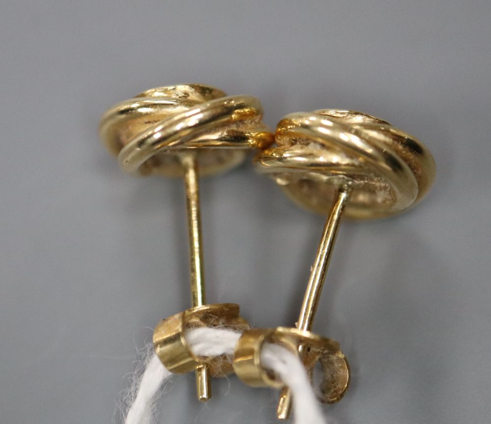 A pair of modern 750 yellow metal and solitaire diamond set knot ear studs, 8mm, gross 3.8 grams.